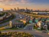 Texas New Homes Are Selling Faster, But Fewer Buyers Are Closing Deals Aerial view of a Texas residential neighborhood and highway near a city skyline, showing new construction homes with "Sold" signs alongside real estate data billboards.